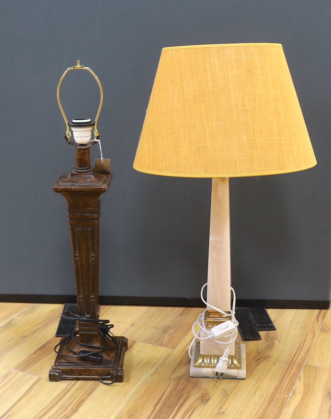 Two Art Deco style lamps comprising a spelter example and an onyx example, the largest 54cm excluding the fitting